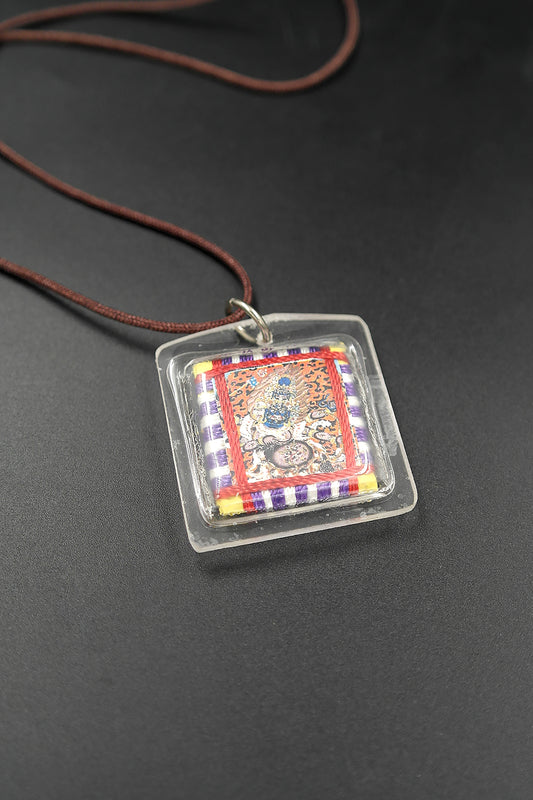 Honor the fierce compassion of Mahakala with Tibetan Sungkhor amulet pendant