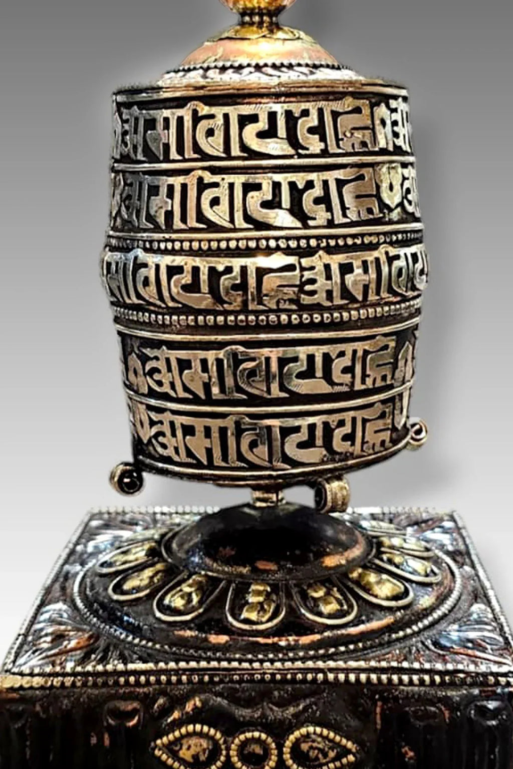Silver colored ovel Shaped Copper Prayer Wheel in Square base, 9" - Vajracrafts