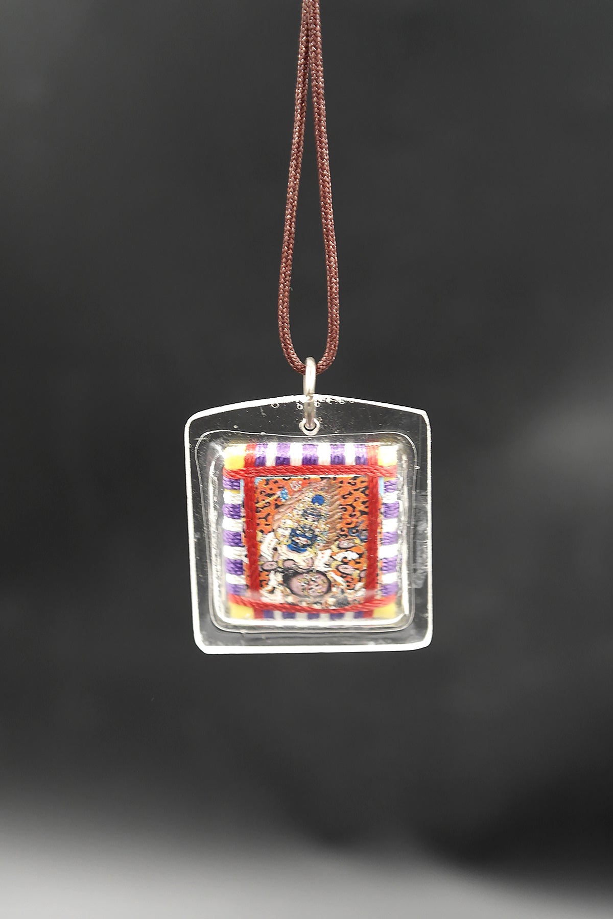 Honor the fierce compassion of Mahakala with Tibetan Sungkhor amulet pendant
