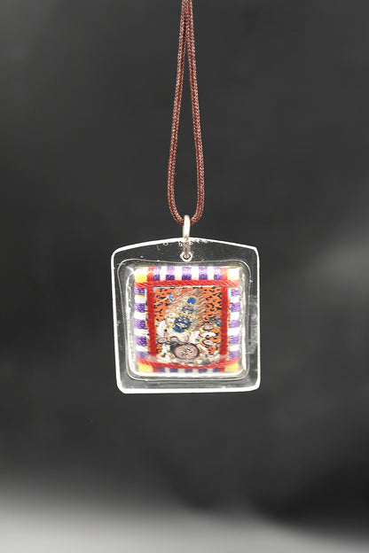 Honor the fierce compassion of Mahakala with Tibetan Sungkhor amulet pendant