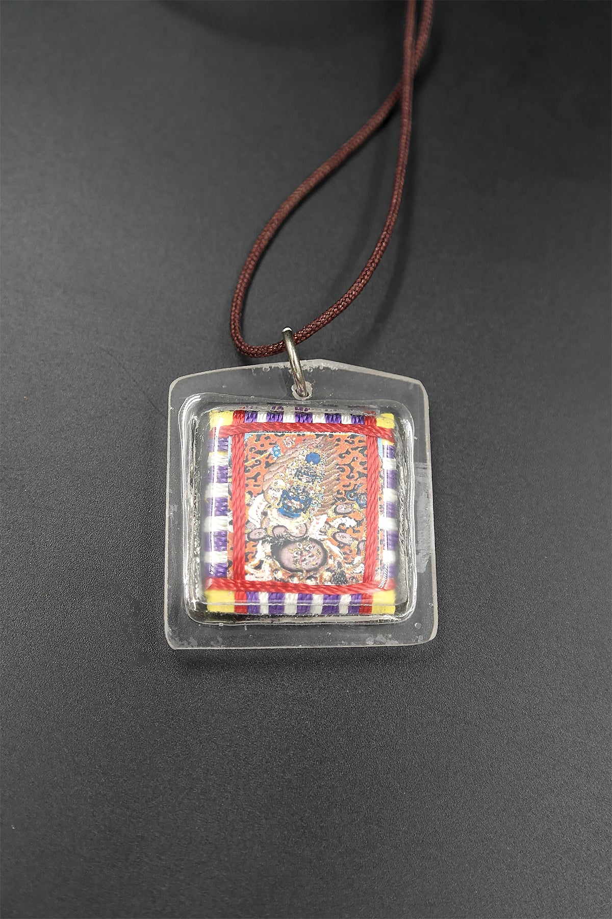 Honor the fierce compassion of Mahakala with Tibetan Sungkhor amulet pendant