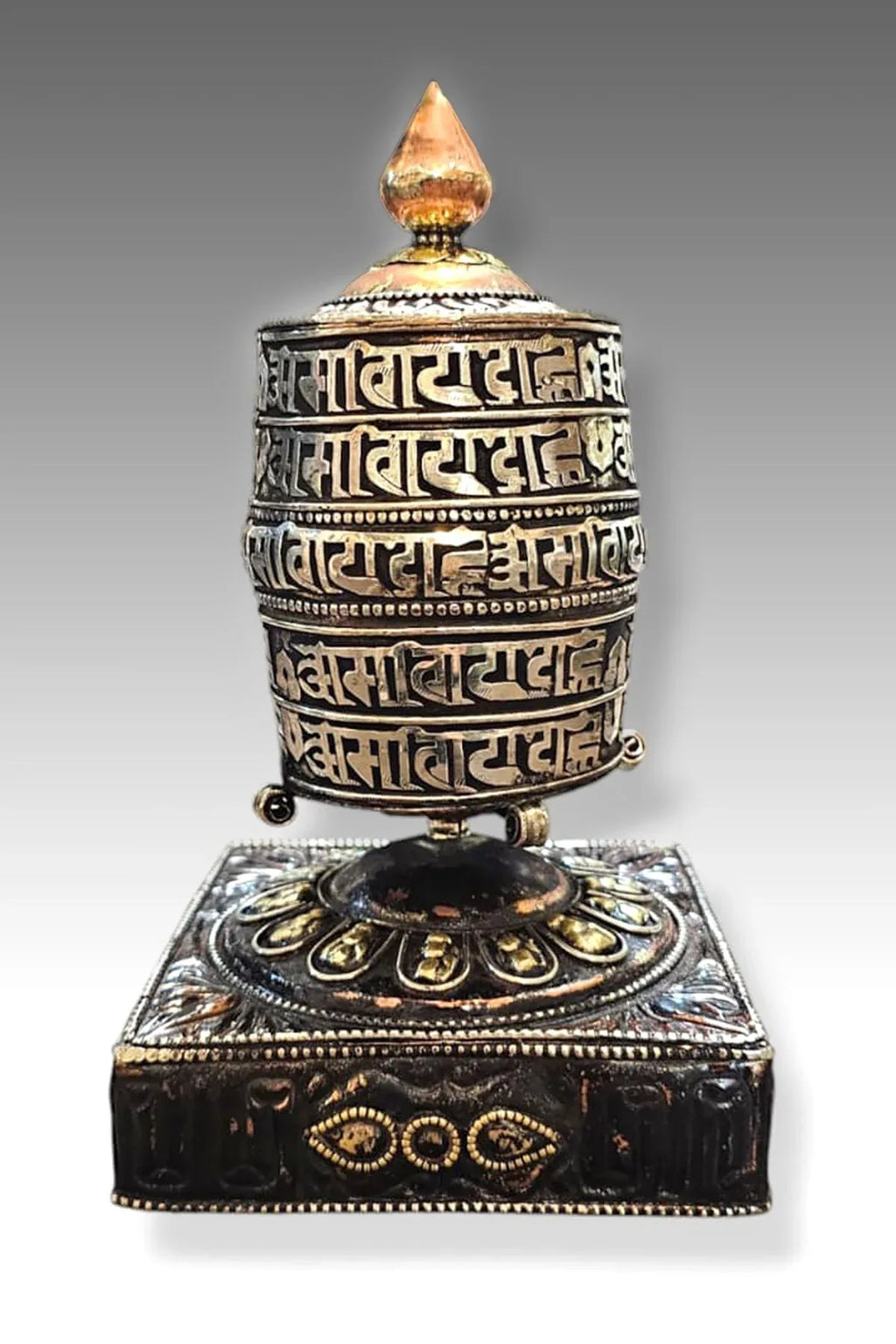Silver colored ovel Shaped Copper Prayer Wheel in Square base, 9" - Vajracrafts