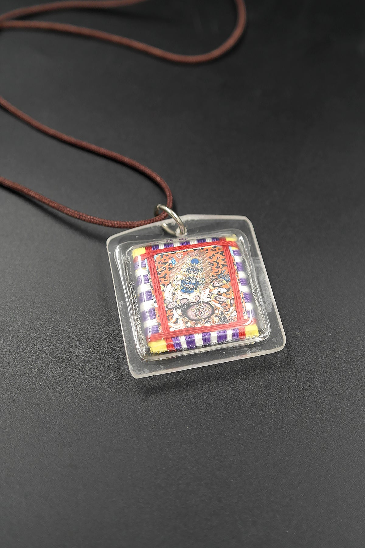 Honor the fierce compassion of Mahakala with Tibetan Sungkhor amulet pendant